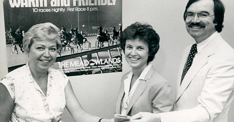 Dot Powers photographed with two others to commemorate an agreement. Black and white photo.