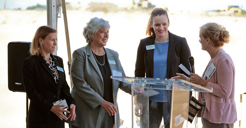 Joananne, Lisa, Michelle, and Donna photographed together before Michelle speaks to Trammell Crow’s investment in Middlesex College.