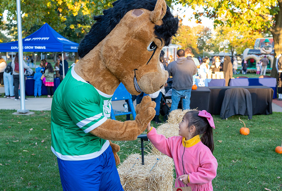 Colt high-fives a young girl.