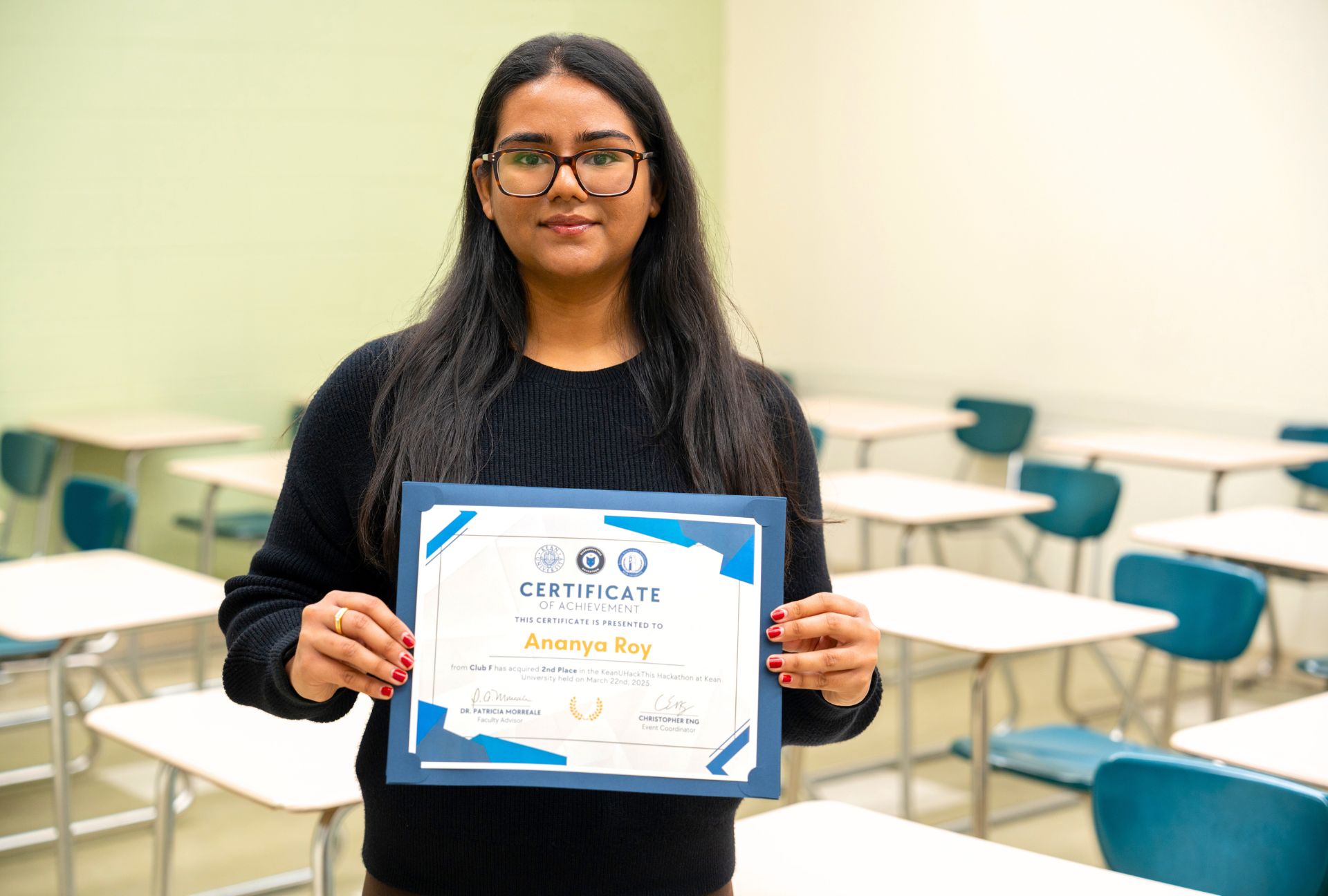 Ananya Roy holding her award