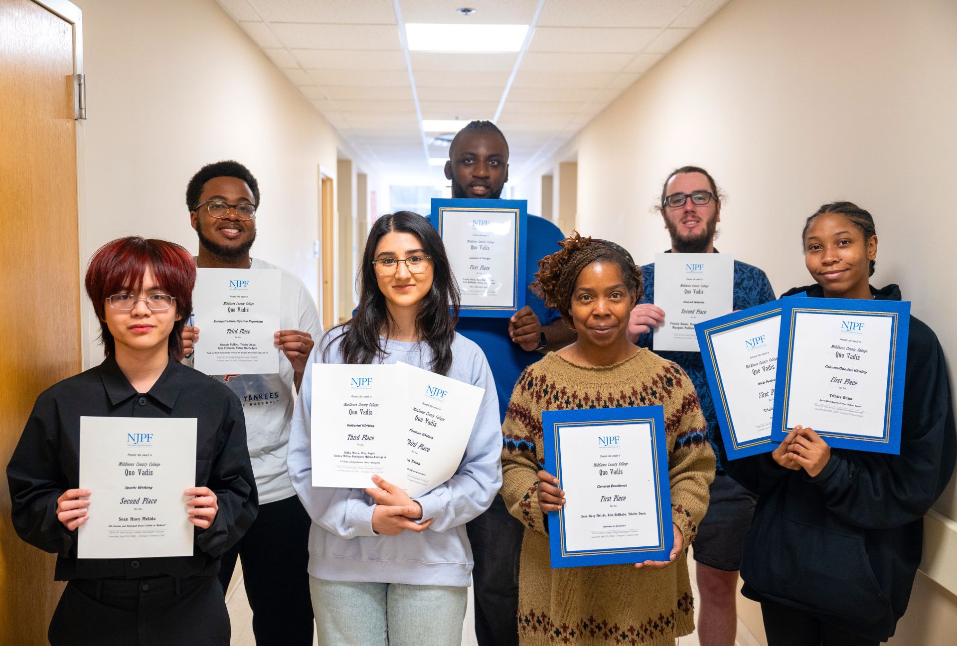 Quo Vadis students and advisor holding their awards