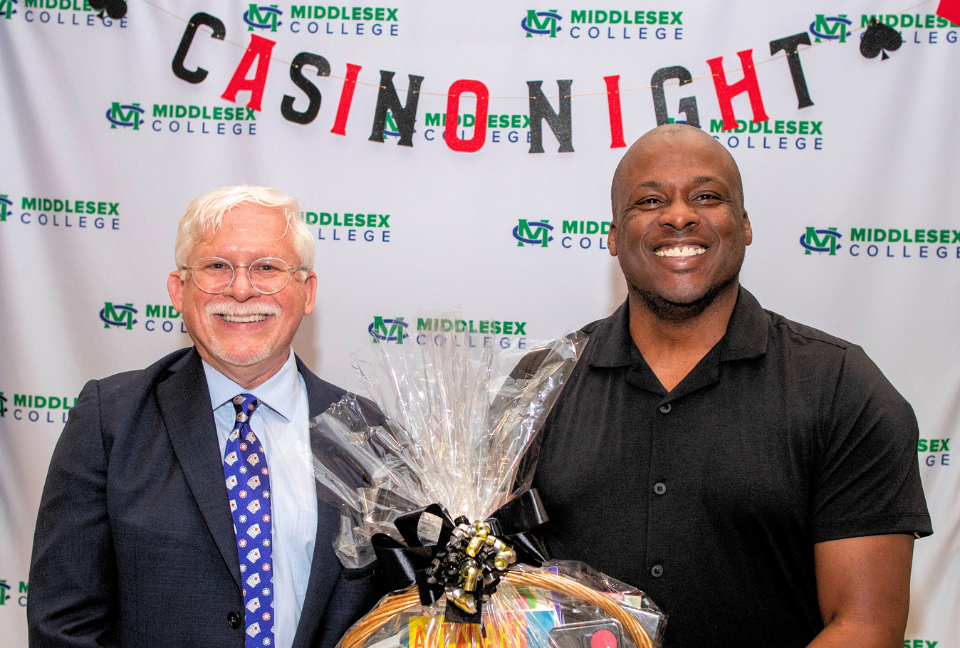 Middlesex College President Mark McCormick with winner of Casino Night basket auction