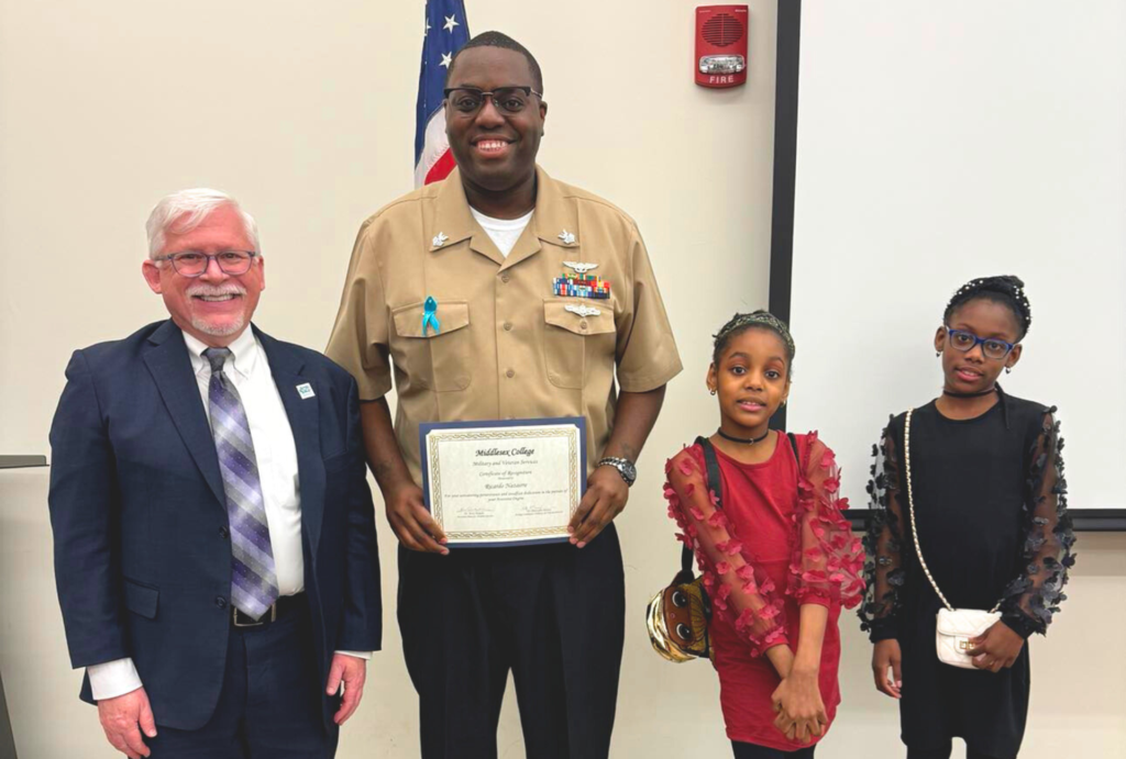 Ricardo with his daughters and Middlesex College President, Mark McCormick