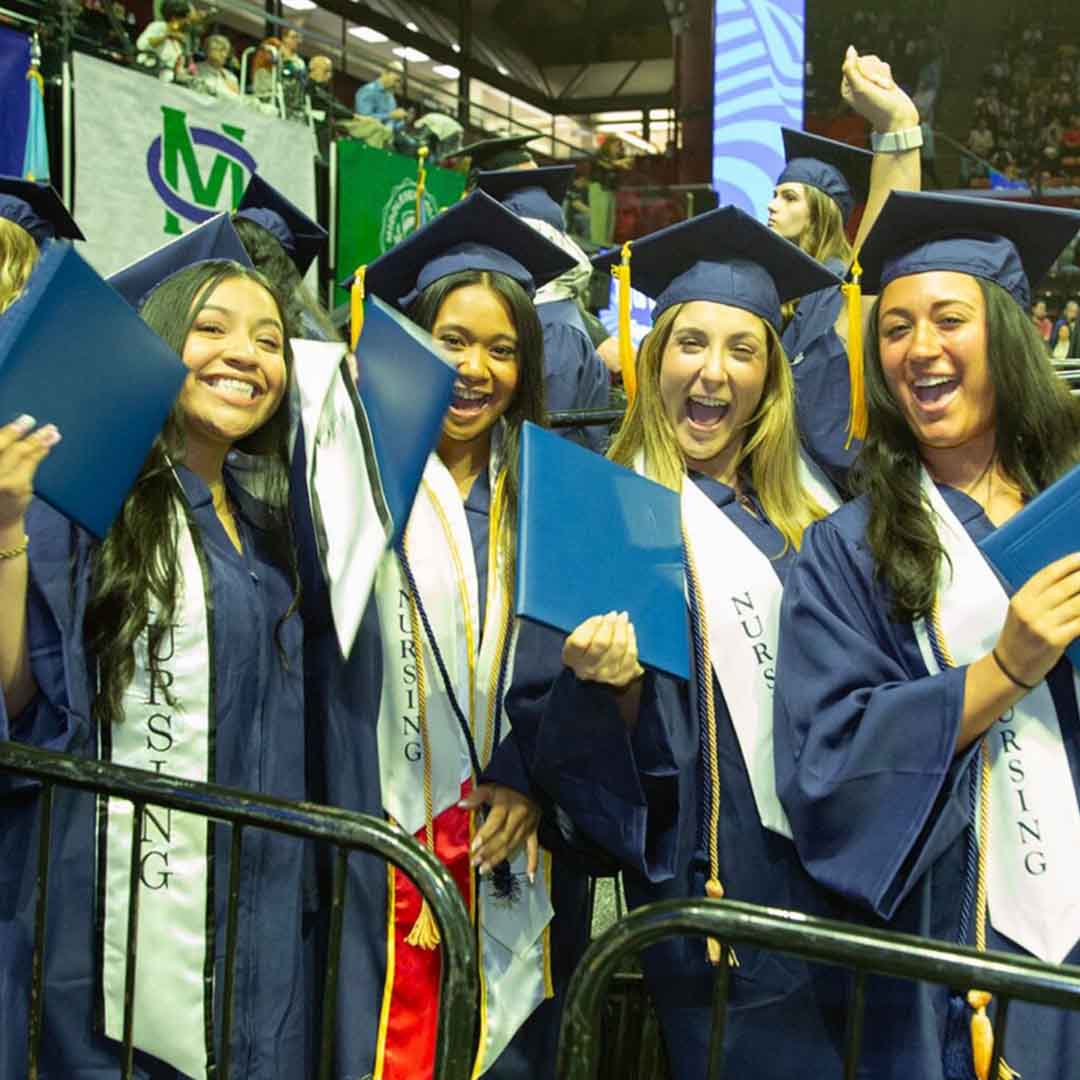 A group of students celebrate the College’s 58th Commencement.
