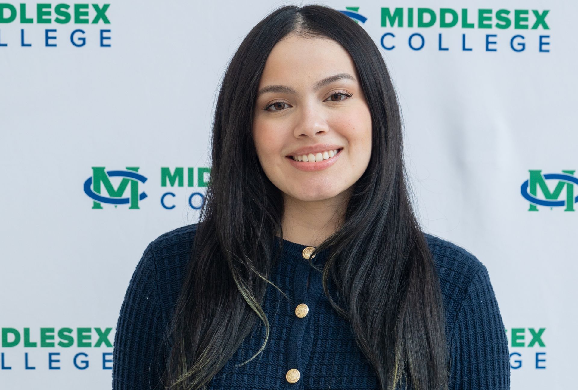 Melissa Ruiz smiling at a Middlesex College event