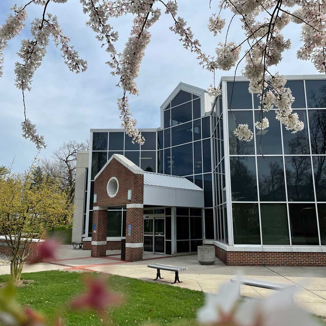 An exterior view of the Instructional Resource Center with Spring trees blooming.