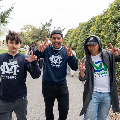 Three students posing during the Open House event.