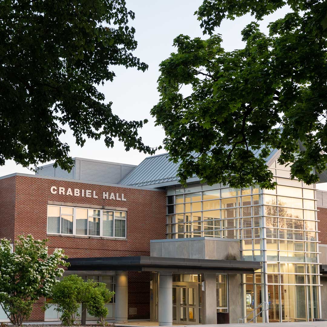 The trees in front of Crabiel Hall are in full bloom for summer.