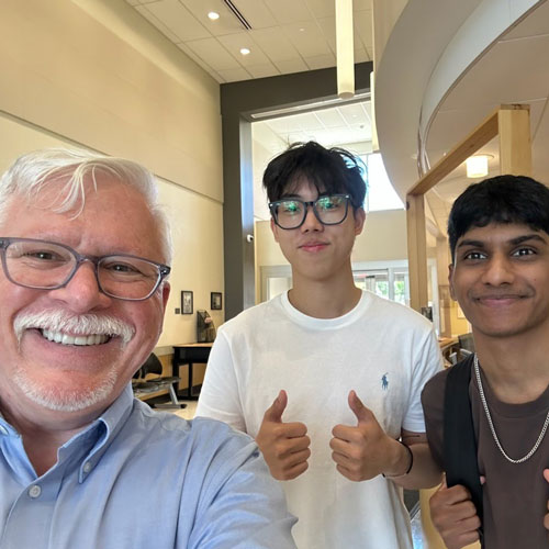 President McCormick taking a selfie with students around campus.